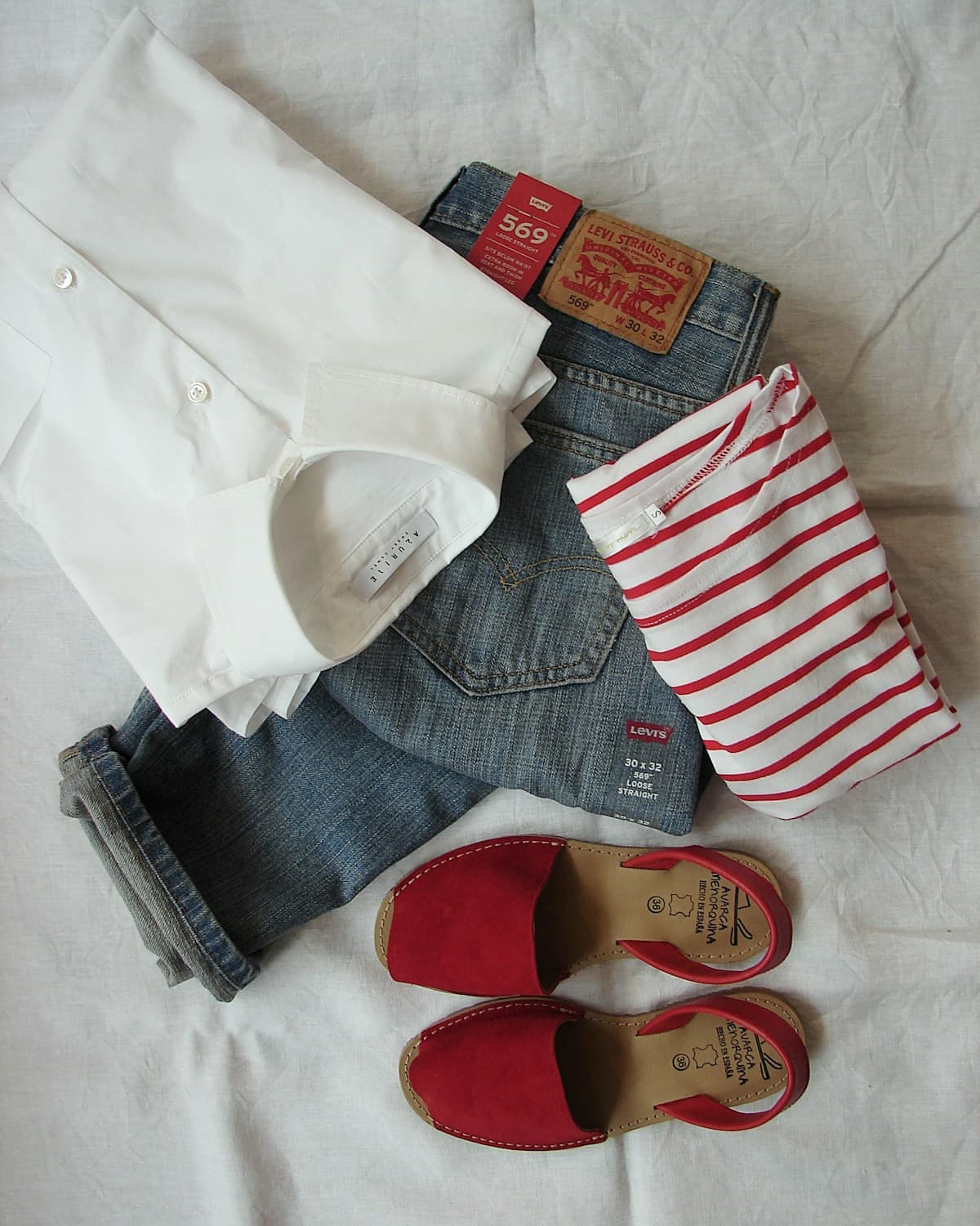 Vintage Levi's jeans and thrift finds laid out for listing